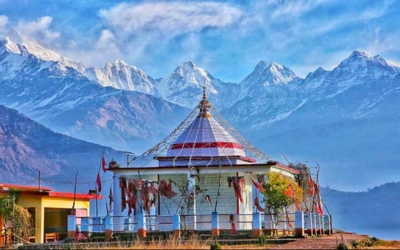 The small, ancient Nanda Devi temple with views of the snow-capped Himalayan peaks